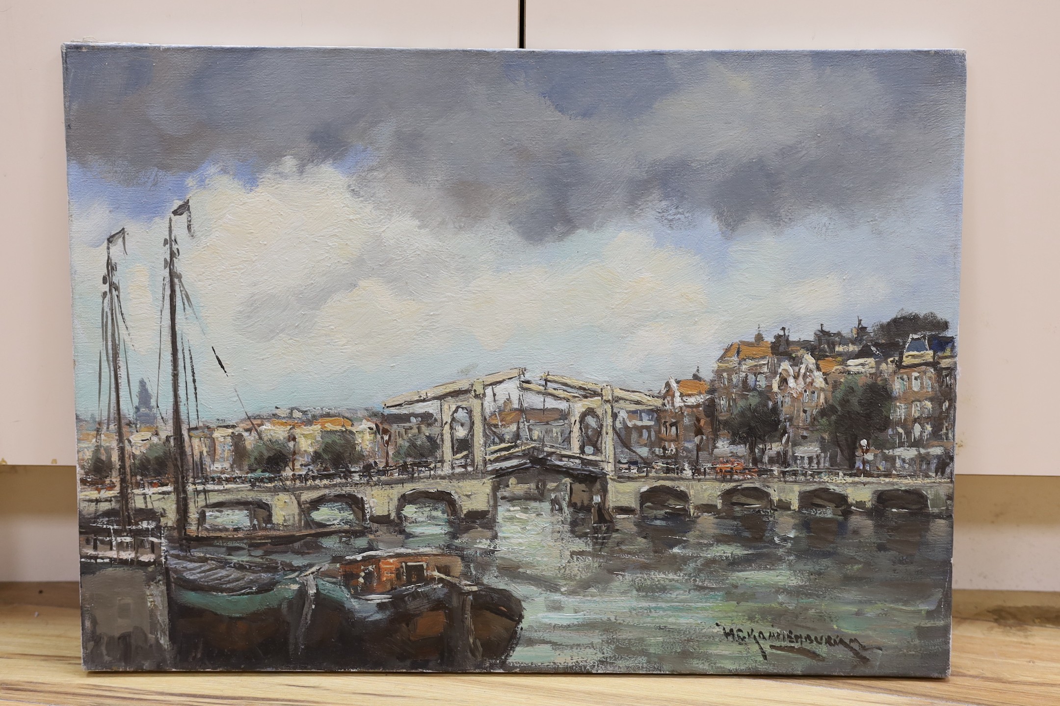 Dutch School, oil on canvas, Bridge in Amsterdam, indistinctly signed, 50 x 70 cm. unframed.